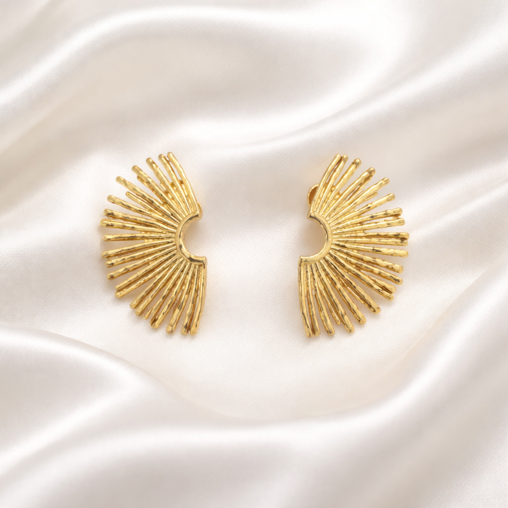 Celeste Sunburst Earrings feature a striking fan-shaped silhouette inspired by radiant light in gold