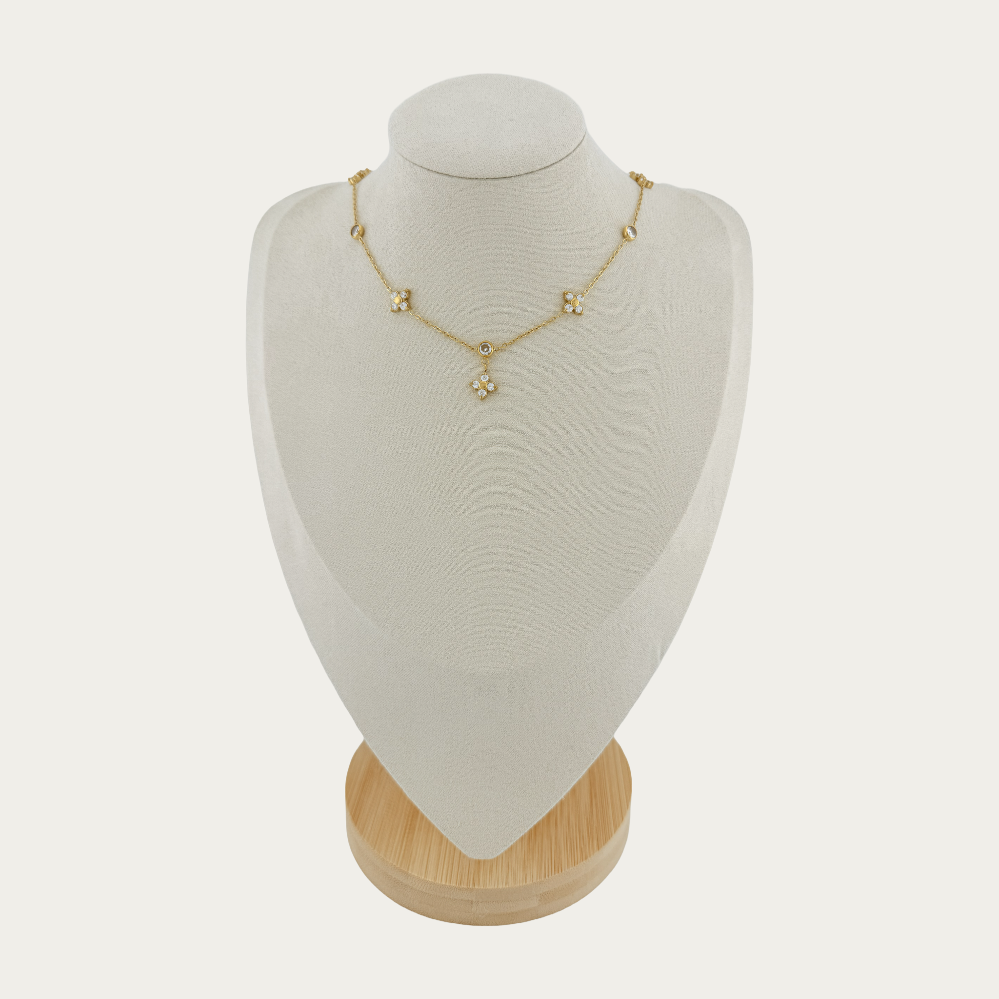 Rosé Floral Chain Necklace with floral motifs adorned with pavé crystal accents on a white mannequin bust