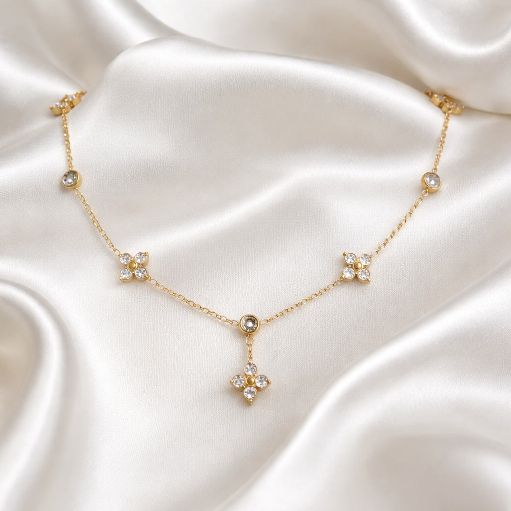 Rosé Floral Chain Necklace features finely detailed floral motifs adorned with pavé crystal accents along a graceful gold chain