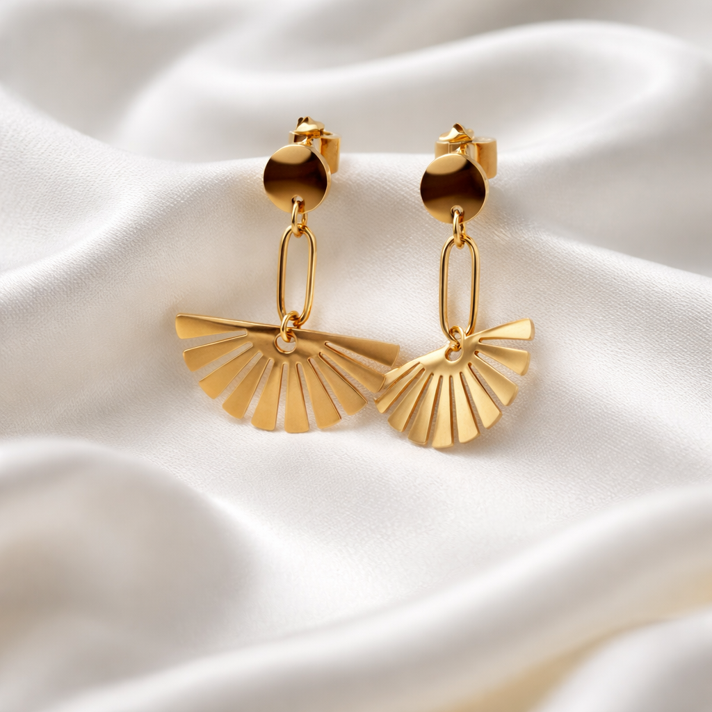 Celeste Fan Drop Earrings feature a sculptural fan silhouette suspended from a sleek drop design, available in gold