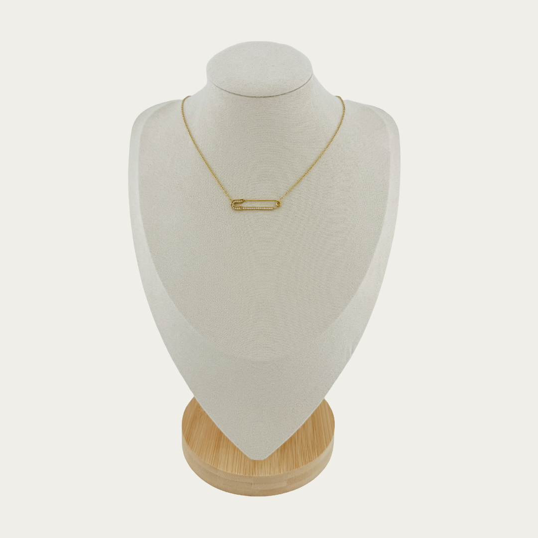 Gold Élan Bar Necklace on a white mannequin bust with a wooden base against a white background