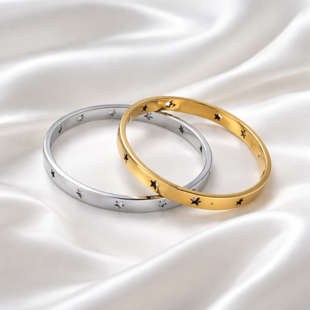 Étoile Bangle features delicate star cut-out detailing set into a sleek, high-polish silhouette, in gold or silver