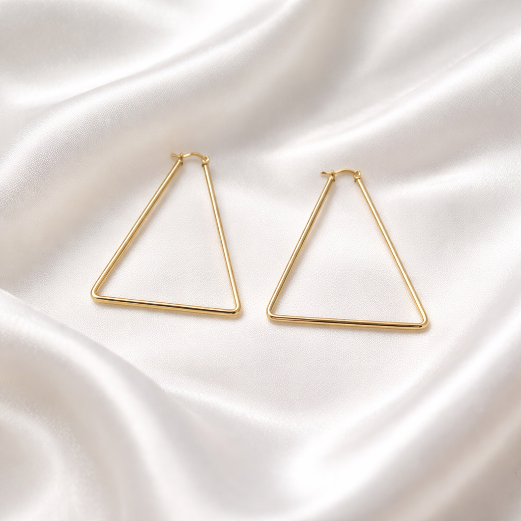 Linea Triangle Hoops feature a modern geometric silhouette designed to bring a clean, lightweight structure