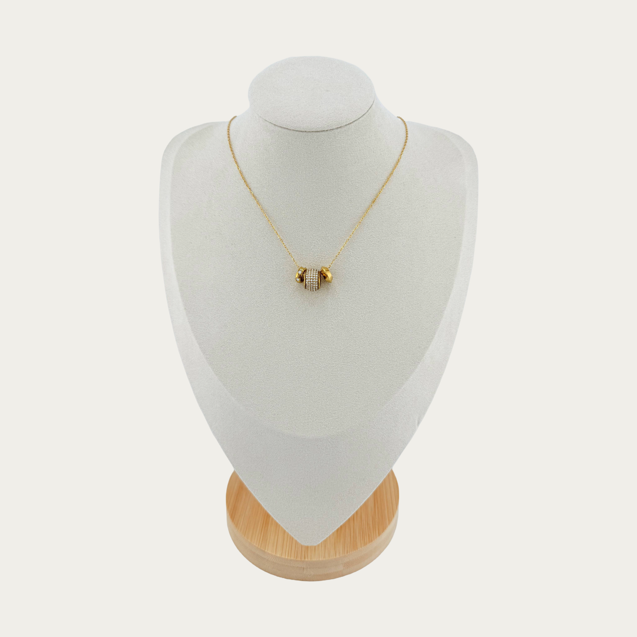 Lumière Pavé Bead Necklace features a softly rounded CZ pavé bead suspended on a delicate gold chain displayed on wooden base