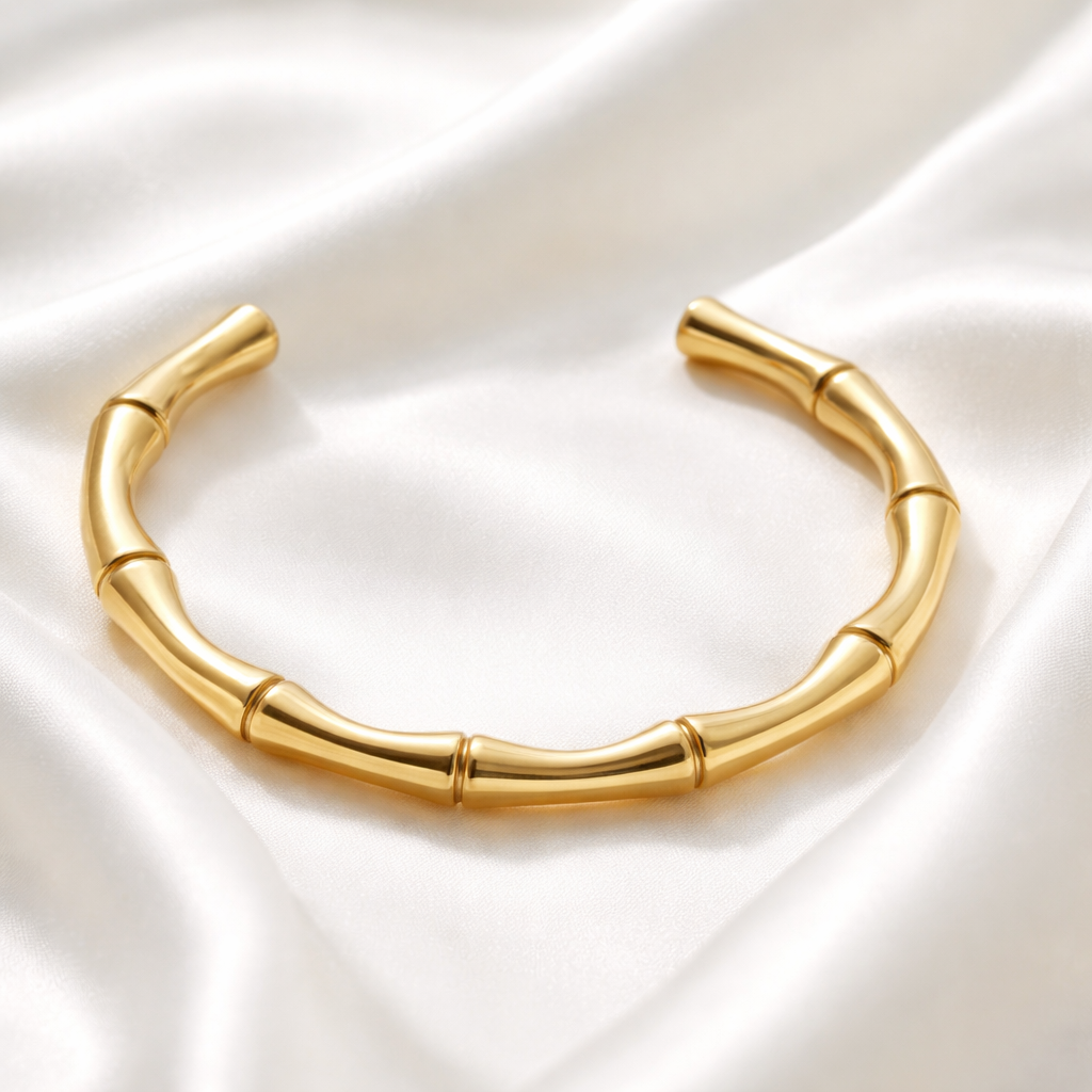 Solace Cuff features a sculptural, segmented silhouette designed to wrap the wrist with its smooth curves and high-polish gold finish.