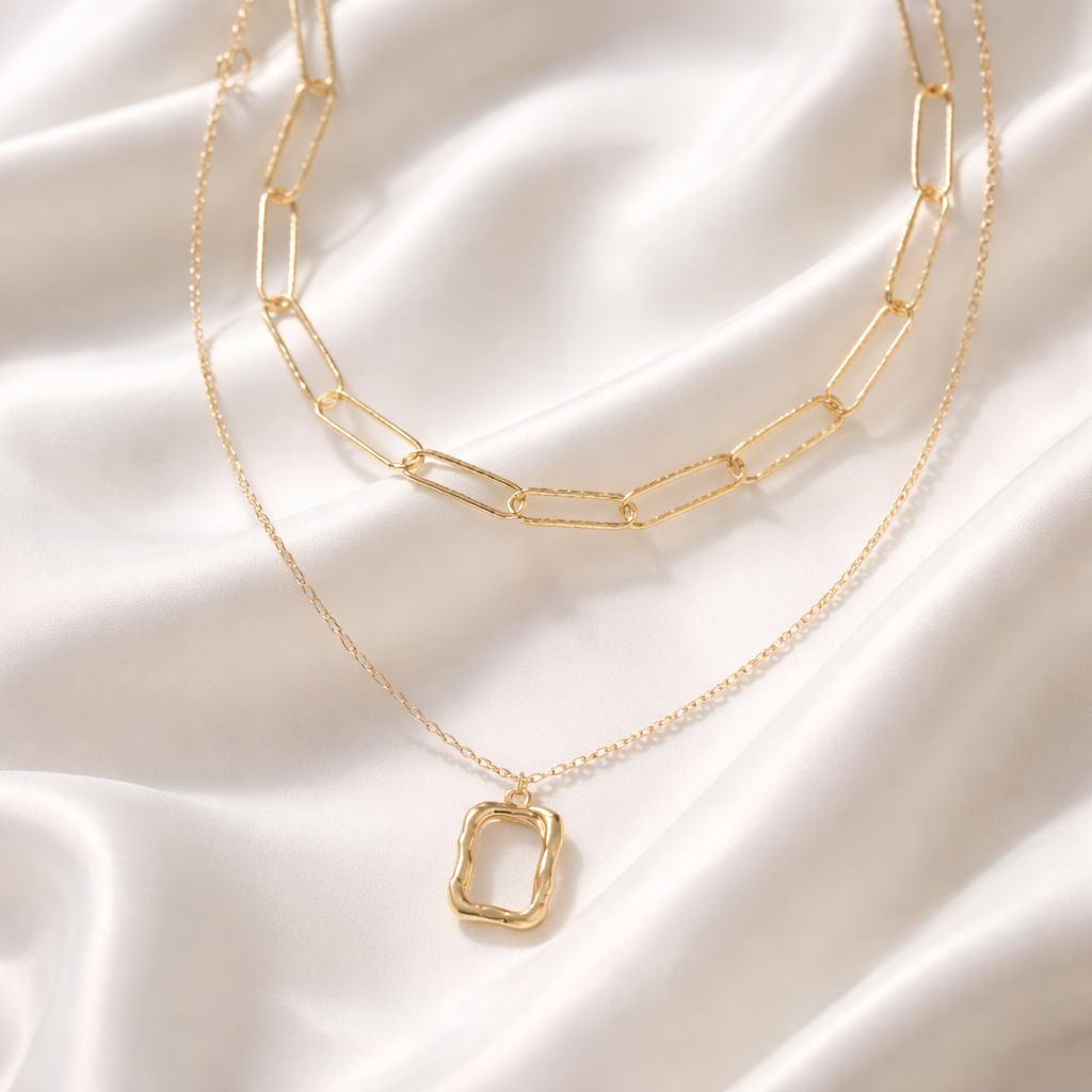 Verve Layered Necklace features a modern mix of chain styles accented with a sculptural pendant